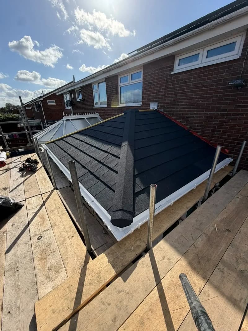 Lightweight tiled conservatory roof conversion adjoining a brick house