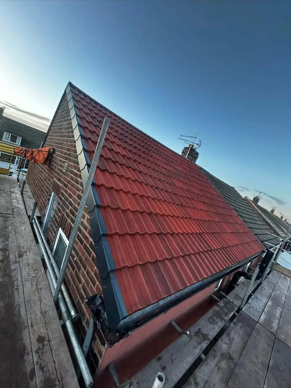 Red tiled gable roof with grey dry verge components