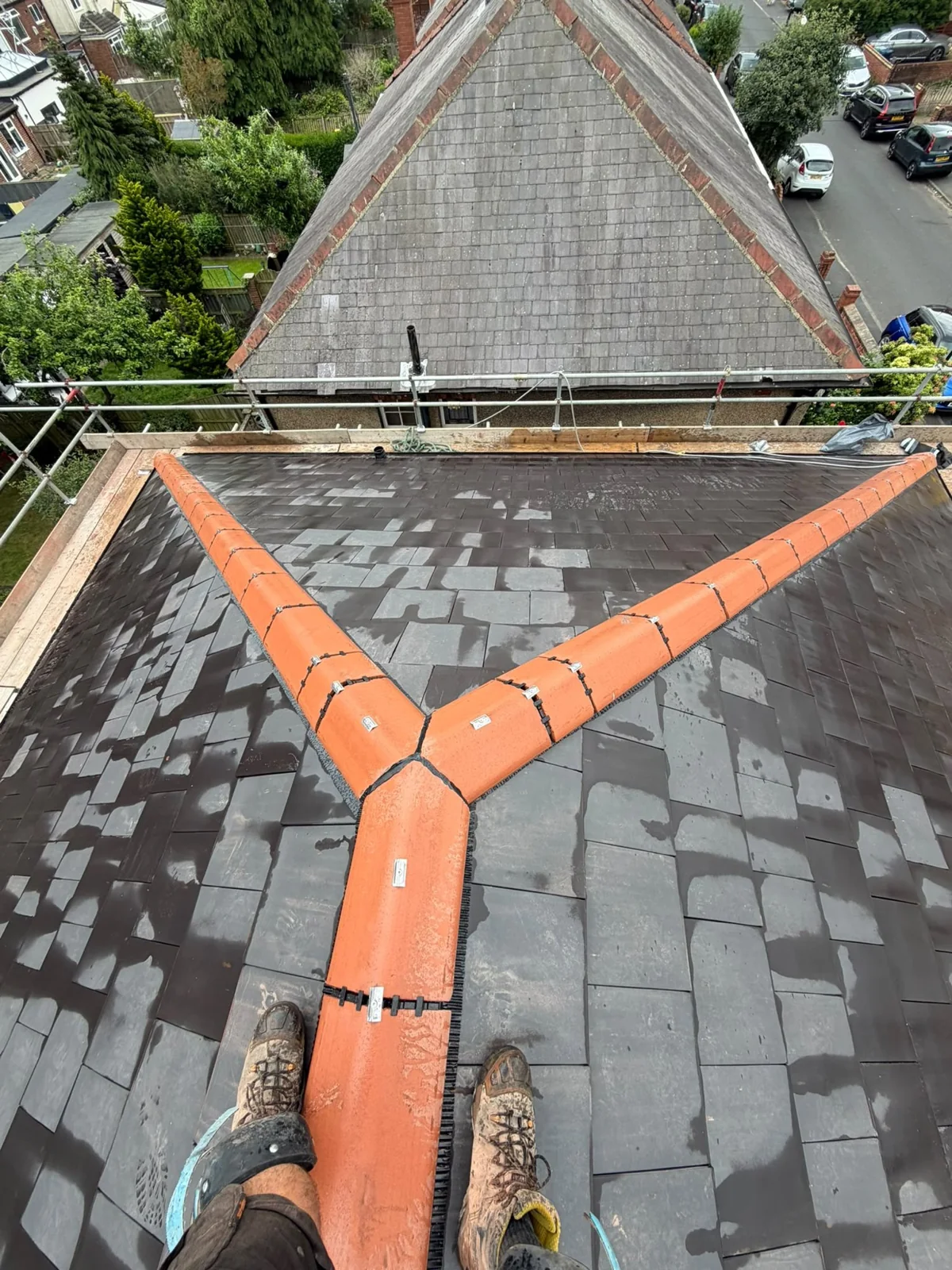 Terracotta ridge hip junction on a new slate roof