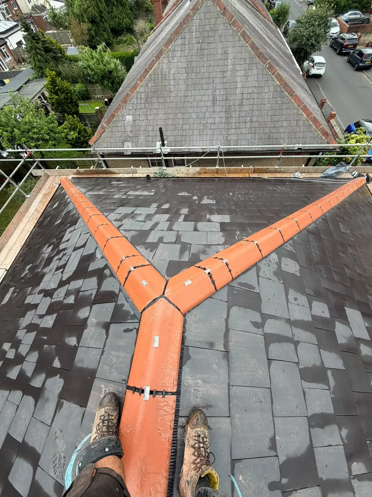 Terracotta ridge hip junction on a new slate roof