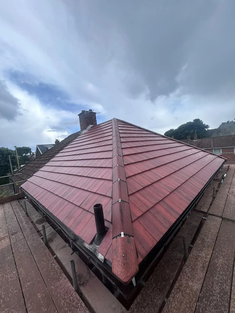 New red concrete tile hip roof with a dry hip junction