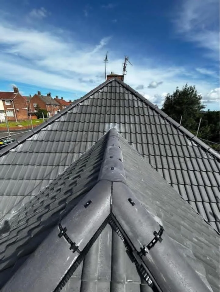 Grey tiled roof with mechanically fixed dry ridge components