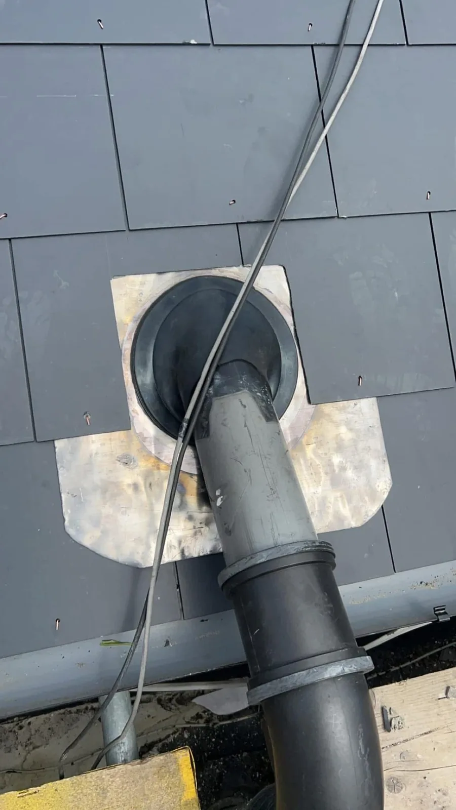 Lead flashing around a soil pipe on a slate roof