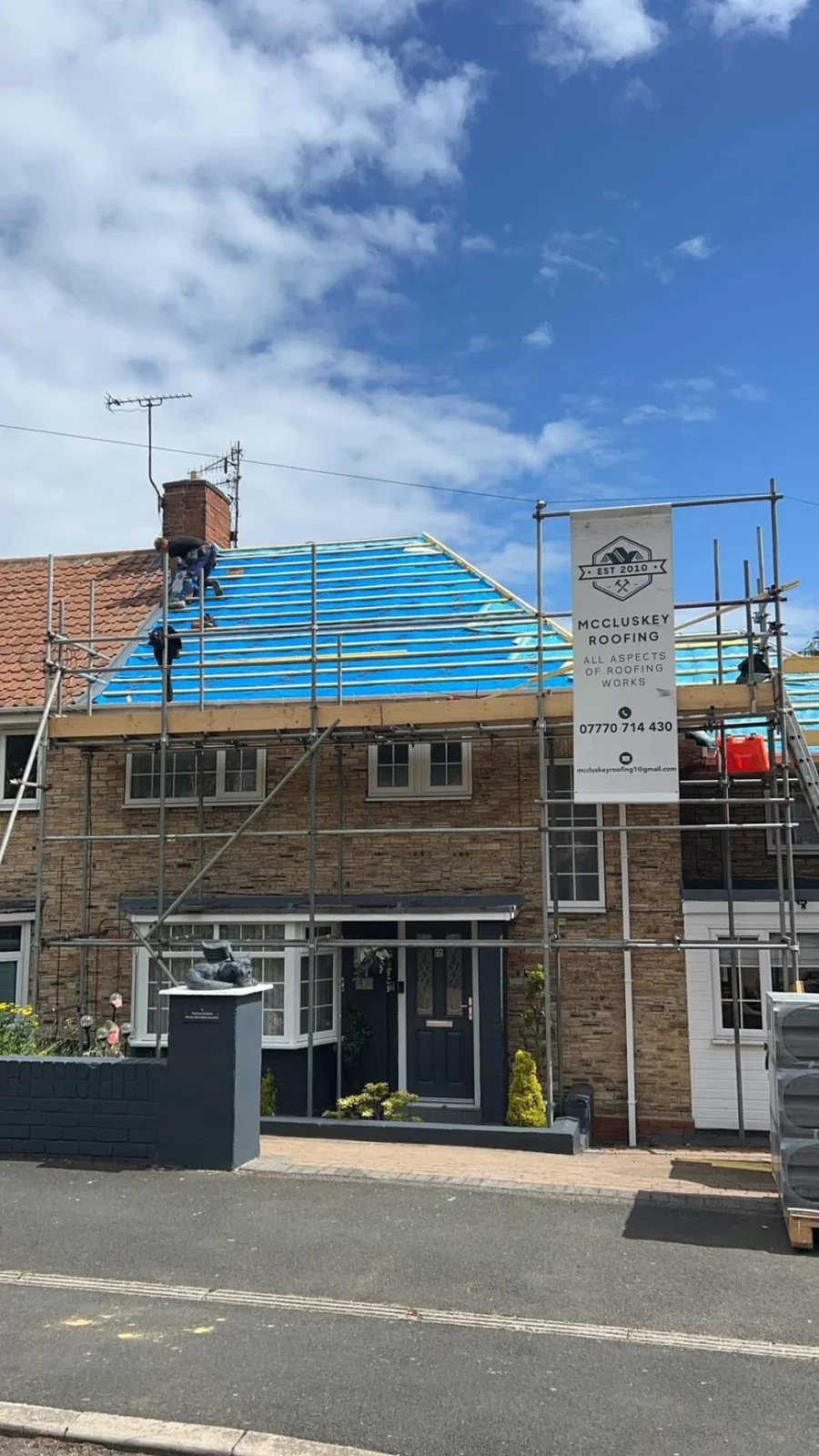 Roof replacement with new membrane, scaffolding and company sign